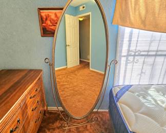 Oval metal floor mirror.