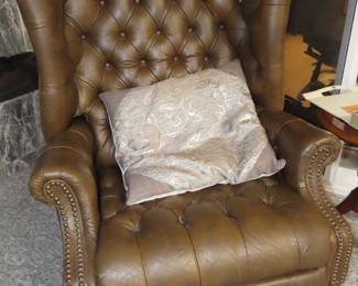 Leather deep tufted pushback recliner.