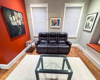 77”x32”x42” IMG Comfort Motorized Dark Brown Leather Power Reclining Sofa, 30”x20”x27” Minimalist Glass and Metal Side Table and original art by Harry Zarin