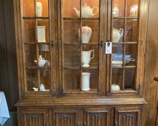 gorgeous lighted three-door china cabinet filled with Lenox decor