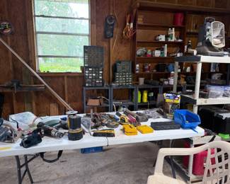Workshop shelves packed with tools, hardware, power tools, toolboxes, organizers, shop supplies, fasteners, storage bins, and miscellaneous garage items.