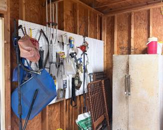 Garage loaded with hand tools, lawn & garden tools, yard equipment, storage cabinet & working refrigerator