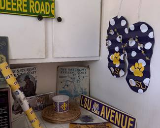     LSU wall décor including hanging LSU flip-flops, street signs, and Tiger fan collectibles.