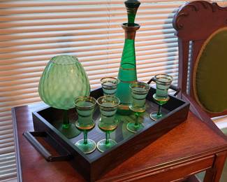 Green art glass decanter set with matching glasses, serving tray, and decorative art glass