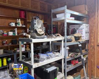 Workshop shelves packed with tools, hardware, power tools, toolboxes, organizers, shop supplies, fasteners, storage bins, and miscellaneous garage items.