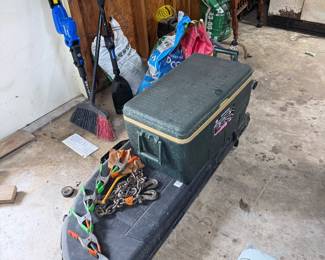 Fishing gear including tackle box, utility sled/gear carrier, and assorted fishing accessories.