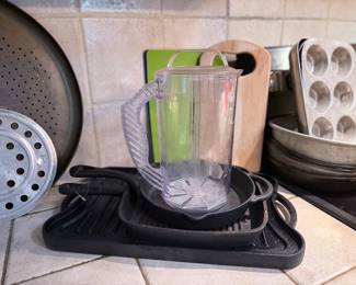 Cast-iron cookware along with plastic pitcher