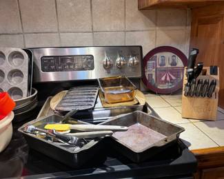 Cast iron, Pyrex, miscellaneous kitchen items, and knife, cutting block with knives