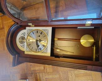 Pendulum wall clock with Roman numeral dial, brass pendulum and weight, decorative case. Mid‑century/late‑20th‑century style. Condition as shown. Buyer pays shipping or local pick up. Price $65.