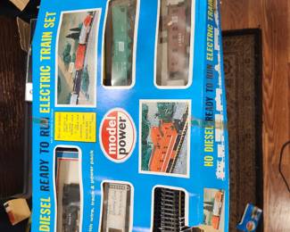 Model Power HO Diesel Ready‑to‑Run Electric Train Set – New Old Stock – Unused – Original Box  Vintage Model Power HO‑scale electric train set, complete and unused, still in the original box. This is true New Old Stock (NOS) — contents appear untouched and never assembled. Includes diesel locomotive, freight cars, track sections, power pack, and accessories. Packaging is clean and intact with clear display windows.  A great collectible for model railroad enthusiasts or anyone looking for a ready‑to‑run HO set in exceptional condition. Hard to find unused examples from this era.  Condition:  New Old Stock (unused)  Original box included  All components present  Box shows only minor shelf wear  Price: $75 Era: Late 1980s–1990s Includes: Locomotive, cars, track, power pack, accessories, original box