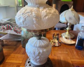 Vintage Milk Glass Hurricane Electric Table Lamp – Cast Iron Base  Price: $50  Beautiful vintage electric hurricane table lamp with embossed white milk glass shade and font, ornate cast iron base, and clear glass chimney. A classic Victorian-style accent perfect for farmhouse, cottage, or traditional décor.  Condition: Good vintage condition with light age-related wear. Includes chimney. Wiring appears intact but should be inspected before use.  Estimated Value:  Estate Sale: $50 Online: $65–100 Antique Shop: $95–150  Buyer pays shipping or local pickup available.