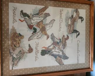 Vintage Framed Waterfowl Needlepoint / Cross-Stitch Wall Art  Beautiful vintage framed needlework artwork featuring several North American waterfowl species, including Canada Geese, Wood Ducks, Mallards, Pintails, and ducklings. The piece is professionally matted and framed in a solid wood frame and would make an excellent addition to a lake house, cabin, hunting lodge, or country-inspired home décor.  The detailed hand-stitched design showcases the artistry and craftsmanship of traditional needlework and offers timeless rustic charm.  Vintage hand-stitched needlework artwork Features Canada Geese, Mallards, Wood Ducks, Pintails, and ducklings Professionally framed and matted Excellent decorative condition Ready to hang Estate fresh find  Price: $75 plus shipping or local pickup.
