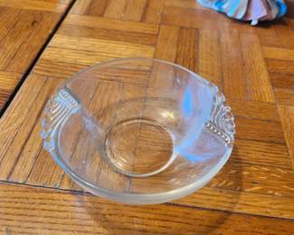 Vintage Clear Glass Console Bowl with Art Deco Handles  Description  Elegant vintage clear glass console bowl featuring decorative Art Deco-style handles and a timeless design. Perfect for serving candy, potpourri, fruit, or as a decorative centerpiece. Its clean lines and classic styling make it a beautiful addition to traditional, farmhouse, or contemporary décor.  This versatile bowl is ideal for display on a dining table, coffee table, buffet, or entryway.  Features:  Vintage clear pressed glass Decorative Art Deco-style handles Multi-purpose serving or display bowl Elegant timeless design  Condition: Good vintage condition with light wear consistent with age. No major chips or cracks visible. Please review all photos for condition.  Estate Sale Price  $15.00  Shipping  Buyer pays actual shipping. Local pickup is also available