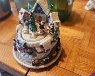 Animated Christmas Village Music Box  Price: $30  Detailed Christmas village music box featuring a winter scene with houses, skaters, train, and festive holiday accents. A charming collectible or holiday display piece.  Condition: Good vintage condition with light wear. Music box sold as found; see photos for condition.  Estimated Value:  Estate Sale: $30 Online: $40–60 Antique Shop: $60–85  Buyer pays shipping or local pickup available.  Lighted Christmas Tree Holiday Decoration  Price: $35  Decorative lighted Christmas tree with ornaments, star topper, and illuminated winter village base. A beautiful tabletop holiday decoration.  Condition: Good vintage condition with light wear. Includes power adapter. Sold as found; see photos.  Estimated Value:  Estate Sale: $35 Online: $45–70 Antique Shop: $65–90  Buyer pays shipping or local pickup available.