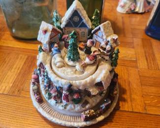 Animated Christmas Village Music Box  Price: $30  Detailed Christmas village music box featuring a winter scene with houses, skaters, train, and festive holiday accents. A charming collectible or holiday display piece.  Condition: Good vintage condition with light wear. Music box sold as found; see photos for condition.  Estimated Value:  Estate Sale: $30 Online: $40–60 Antique Shop: $60–85  Buyer pays shipping or local pickup available.  Lighted Christmas Tree Holiday Decoration  Price: $35  Decorative lighted Christmas tree with ornaments, star topper, and illuminated winter village base. A beautiful tabletop holiday decoration.  Condition: Good vintage condition with light wear. Includes power adapter. Sold as found; see photos.  Estimated Value:  Estate Sale: $35 Online: $45–70 Antique Shop: $65–90  Buyer pays shipping or local pickup available.