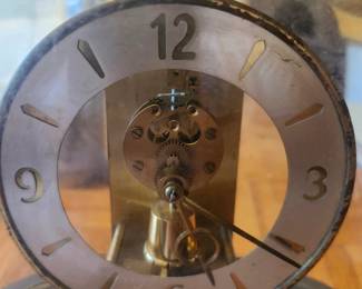 Vintage Kundo 400-Day Anniversary Clock – West Germany – 6 Jewel Movement  Elegant vintage Kundo (Kieninger & Obergfell) 400-day anniversary clock featuring a brass-tone movement with a glass dome. Made in West Germany, this classic mechanical clock is powered by a precision 6-jewel movement and is designed to run for up to 400 days on a single winding. A beautiful collectible for clock enthusiasts or anyone who appreciates mid-century German craftsmanship.  Manufacturer: Kundo (Kieninger & Obergfell) Origin: Made in West Germany Movement: Mechanical 6-Jewel, 400-Day (Anniversary) Approximate Year: 1955–1965 Condition: Good vintage condition with age-appropriate patina. Glass dome included. Running condition unknown unless tested. Please review all photos carefully. Suggested Estate Sale Value  Price: $75 Running & Keeps TimeServiced / Excellent Condition: $175–250 Shipping  Buyer pays actual shipping. Local pickup is also available.