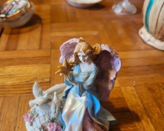 Vintage Angel Figurine with Doves & Star – Inspirational Home Décor  Description  Beautiful vintage angel figurine featuring flowing robes, detailed wings, a gold star, doves, and floral accents. This peaceful and inspirational decorative piece makes a wonderful addition to a curio cabinet, mantel, bookshelf, or holiday display. A thoughtful gift for collectors of angel figurines or anyone who appreciates faith-inspired home décor.  The soft pastel colors and detailed craftsmanship make this an attractive accent for year-round display.  Features:  Detailed angel with gold star Decorative doves and floral accents Hand-painted resin construction Soft pastel finish Perfect for home décor or gift giving  Condition: Good vintage condition with light wear consistent with age. No major damage visible. Please review all photos for condition.  Estate Sale Price  $20.00  Shipping  Buyer pays actual shipping. Local pickup is also available.
