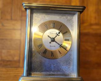 Ridgeway Quartz Mantel Clock – Made in Germany  Elegant Ridgeway quartz mantel clock featuring a polished brass-tone case, decorative engraved dial, and classic Roman numerals. This carriage-style clock adds timeless style to a desk, mantel, bookshelf, or office. Precision German quartz movement provides reliable timekeeping with minimal maintenance. A beautiful decorative and functional piece for any home.  Manufacturer: Ridgeway Movement: German Quartz Country of Origin: Made in Germany Approximate Year: 1980s–1990s Condition: Good vintage condition with light wear consistent with age. Please review photos for cosmetic condition. Battery not included. Suggested Estate Sale Value Quick Sale: $20–25 Middle-of-the-Road Price:  Excellent Condition / Working: $45 Shipping  Buyer pays actual shipping. Local pickup is also available.