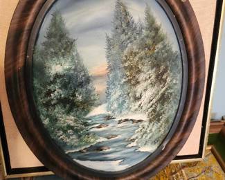 Beautiful vintage hand-painted winter landscape featuring snow-covered evergreens and a flowing stream, presented in an attractive oval wood-grain frame. This charming mid-century decorative piece would look wonderful in a cabin, farmhouse, or traditional home setting. A timeless winter scene with excellent decorative appeal.  Price: $65 plus shipping or local pickup.