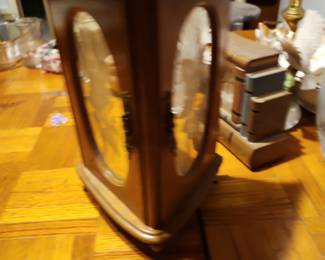 Vintage Wooden Curio Display Cabinet Description: Vintage tabletop wooden curio display cabinet with beveled glass panels and mirrored interior. Ideal for displaying collectible figurines, pocket watches, jewelry, or keepsakes. Features a classic wood finish and elegant display design. Brand: Unknown (no visible maker's mark) Estimated Year: 1980–2000 Condition: Good vintage condition with normal wear. Glass appears intact. Mid-Range Estate Value: $30 Facebook Marketplace: $40–60 eBay List Price: $49.99 + shipping  Buyer pays shipping or local pickup available