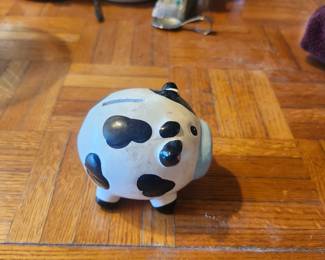 Ceramic Cow Piggy Bank  Price: $10  Cute ceramic cow piggy bank with coin slot. Great for farmhouse décor, kids' room, or collectors.  Condition: Good pre-owned condition with light wear.  Estimated Value:  Estate Sale: $10 Online: $15–20 Gift Shop: $20–30  Buyer pays shipping or local pickup available.
