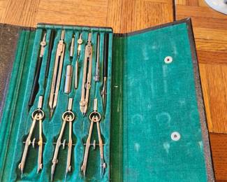 Description: Vintage drafting and engineering instrument set complete with multiple precision compasses, dividers, ruling pen, extension bars, lead holder, and accessories in the original fitted carrying case. This professional-quality drafting set was designed for architects, engineers, surveyors, and technical illustrators before the CAD era. The instruments appear to be in good vintage condition with normal signs of age and use. Great addition for collectors, display, restoration, or anyone interested in vintage drafting tools.  Manufacturer: Unknown (markings not visible) Approximate Year: Circa 1950s–1970s Condition: Good vintage condition with original case; appears substantially complete. Includes: Original fitted case with multiple drafting instruments and accessories.  Suggested Estate Sale Price:  Quick Sale: $30–40