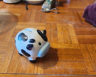 Ceramic Cow Piggy Bank  Price: $10  Cute ceramic cow piggy bank with coin slot. Great for farmhouse décor, kids' room, or collectors.  Condition: Good pre-owned condition with light wear.  Estimated Value:  Estate Sale: $10 Online: $15–20 Gift Shop: $20–30  Buyer pays shipping or local pickup available.