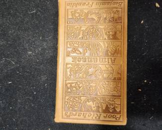 Leather‑Bound Poor Richard’s Almanack – Benjamin Franklin – 1917 Century Co. Facsimile Edition – Gift Inscription (1905)  Beautiful leather‑bound facsimile edition of Benjamin Franklin’s Poor Richard’s Almanack, published by The Century Co. in 1917. Features an embossed leather cover with detailed panels, gilt celestial spine design, and a frontispiece portrait of Franklin. Interior pages are clean and well‑preserved. Includes a handwritten gift inscription dated Christmas 1905, adding historical charm and provenance.  This edition is part of a limited series of high‑quality reproductions of the original 1733 almanac. A wonderful collector’s piece, gift item, or display book.  Condition:  Leather cover in great shape  Tight binding  Clean pages  Gift inscription inside front cover  No major damage or odors  Price: $55 Year: 1917 (facsimile edition) Includes: Leather binding, gift inscription