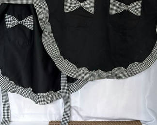 Lot 148: Aprons and woven placemats set