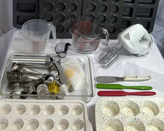 Lot 119: Baking supplies set with muffin pans, hand mixer, and measuring tools