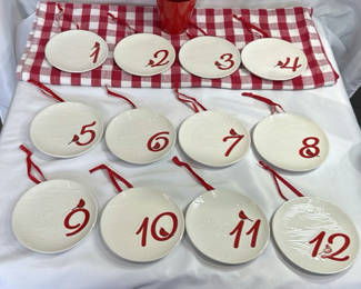 Lot 118: Twelve white ceramic plates with red numerals 1–12 and bird motif, each with red hanging ribbon