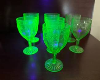 7 green depression glass (glows) goblets with Cameo pattern