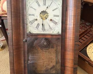 Mahogany veneered ogee clock likely dating from mid 19th century by Gilbert and Co.