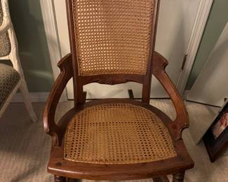 Victorian rocker with cane back and carving