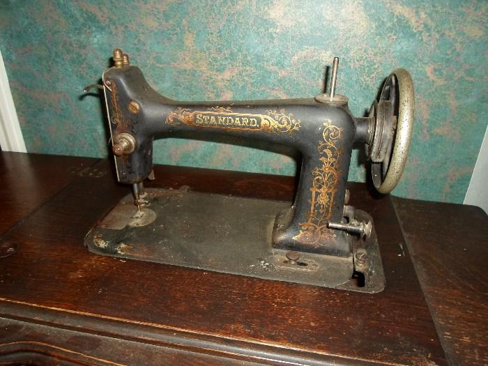 Standard treadle sewing machine in cabinet