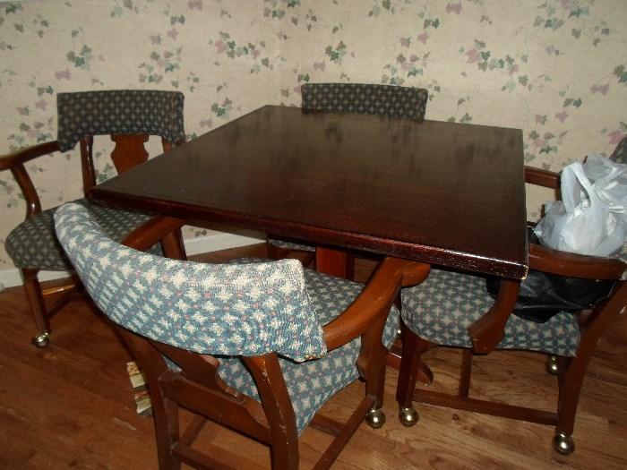 nice game table w/4 chairs on rollers