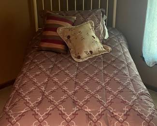 Twin bed with unused mattress. 