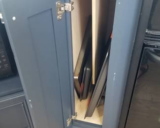 Kitchen island feature: cutting board storage. Baking sheets