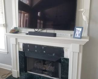 Gas fireplace insert; mantel. Owner keeping TV & sound bar