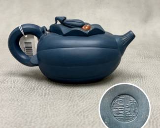A Chinese blue clay melon-form teapot styled after traditional Yixing zisha pottery, with a decorative frog and leaf design on the lid