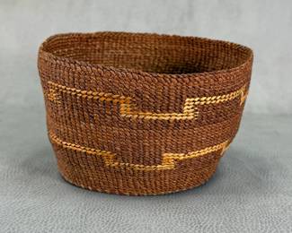 Handwoven Northwest Coast Tsimshian basket with warm brown tones and lighter geometric accent banding, coiled weave natural fibers, approx 4"W x 6"H