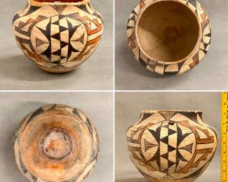 More views of the Acoma Pueblo olla—a water jar or storage vessel—formed from hand-coiled clay decorated with a white slip background, accented by vibrant polychrome geometric panels and stylized bird or feather elements. Approximately 8-1/4” tall. Repairs as shown. 