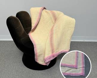A lightweight handwoven bed coverlet featuring delicate pink and purple striped borders along an off-white base