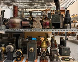 Amazing collection of antique magic lanterns, kinematographs, and projectors including several by  Ernst Plank, Germany; a 35mm Toy Movie Viewer circa 1920; a French magic lantern by Lapierre, Lanterne Carrée model; and an antique Radioptican postcard projector made by the H.C. White Company of North Bennington, Vermont, around 1910–1915.