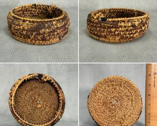 More view of the small handwoven round basket in natural brown fibers with a simple coiled construction
