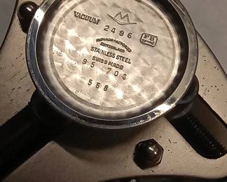 Closeup view of the 1950s-60s vintage Movado M95 "SUB-SEA" Chronograph wrist watch with black leather strap, in the original box. This watch has Movado Factories Swiss in-house Calibre M95 - a 17-jewel, manual-wind, column-wheel chronograph movement developed in partnership with Frédéric Piguet. Case is stainless steel, Fabrique de Boîtiers (FB) / François Borgel. Screw-down caseback stamped with Movado crown, case no. 2496, ref. 95.704.568 with "SUB-SEA" engraved on the case band.
