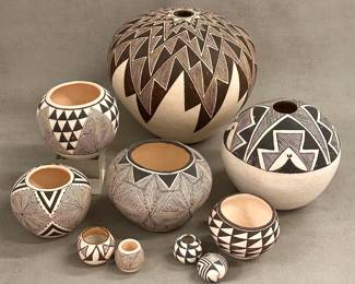 Southwestern Native American pottery from the Acoma Pueblo artisans, including large seed jars with dynamic geometric decorations by Gilbert Chino and Elizabeth Wakonda; hand-coiled local clay storage jars or ollas painted in white slip with black geometric patterns by Pablita Concho, Lucy M. Lewis, and V. Victorino. 