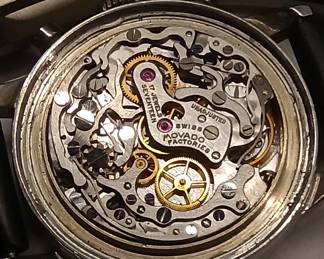 Closeup view of the 1950s-60s vintage Movado M95 "SUB-SEA" Chronograph wrist watch with black leather strap, in the original box. This watch has Movado Factories Swiss in-house Calibre M95 - a 17-jewel, manual-wind, column-wheel chronograph movement developed in partnership with Frédéric Piguet. Case is stainless steel, Fabrique de Boîtiers (FB) / François Borgel. Screw-down caseback stamped with Movado crown, case no. 2496, ref. 95.704.568 with "SUB-SEA" engraved on the case band.