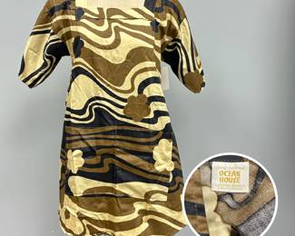 A vintage Ocean House California abstract wave and floral print apron dress / house dress with short sleeves, a square neckline, and prominent dual front patch pockets.  Retro psychedelic swirling wave pattern in earthy shades of brown, tan, and black, accented by simple 5-petal flower graphics