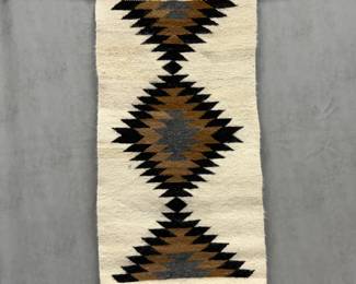 Diné Navajo Gallup throw c. 1970s, with black, brown, and gray serrated diamond geometric patterns on an ivory background; 19.5" x 38.5"